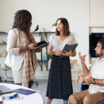 CEO discussing inclusive leadership with diverse team members