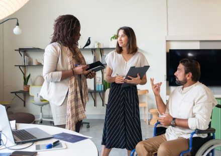 CEO discussing inclusive leadership with diverse team members