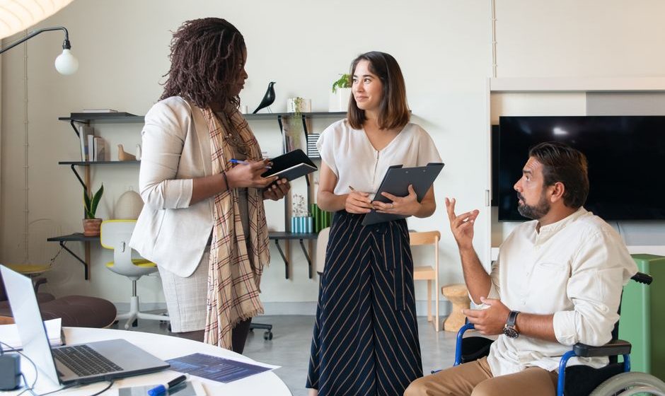 CEO discussing inclusive leadership with diverse team members
