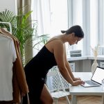 A woman entrepreneur sitting confidently at her desk, representing empowerment and breaking free from limiting beliefs.